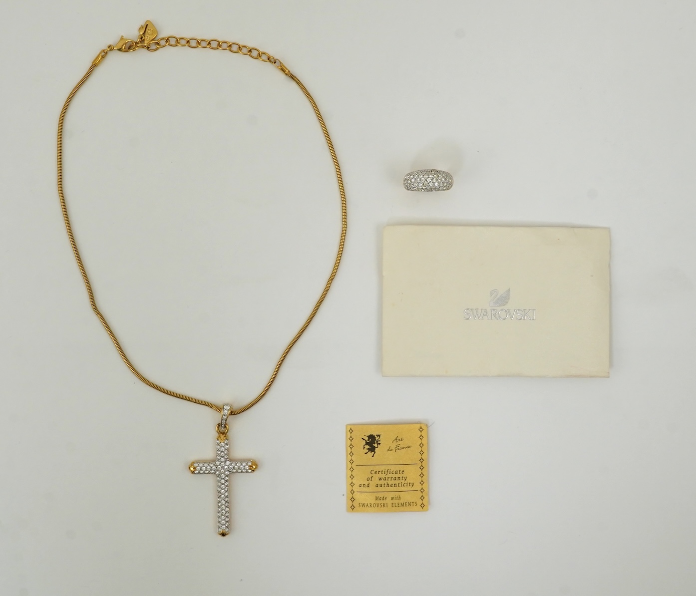 A Swarovski vintage cross necklace and ring.